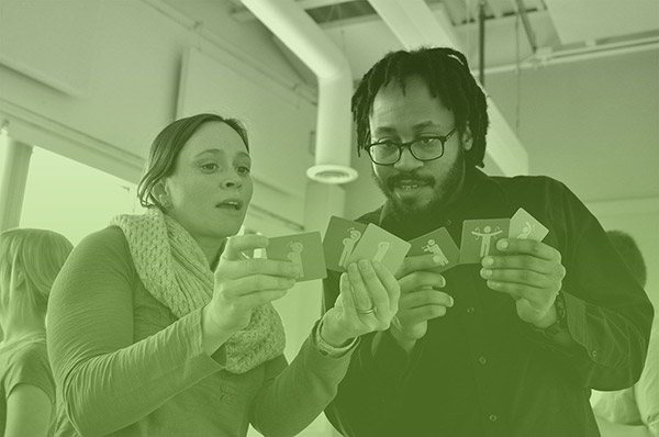 A man and woman interact together while using the We Connect cards